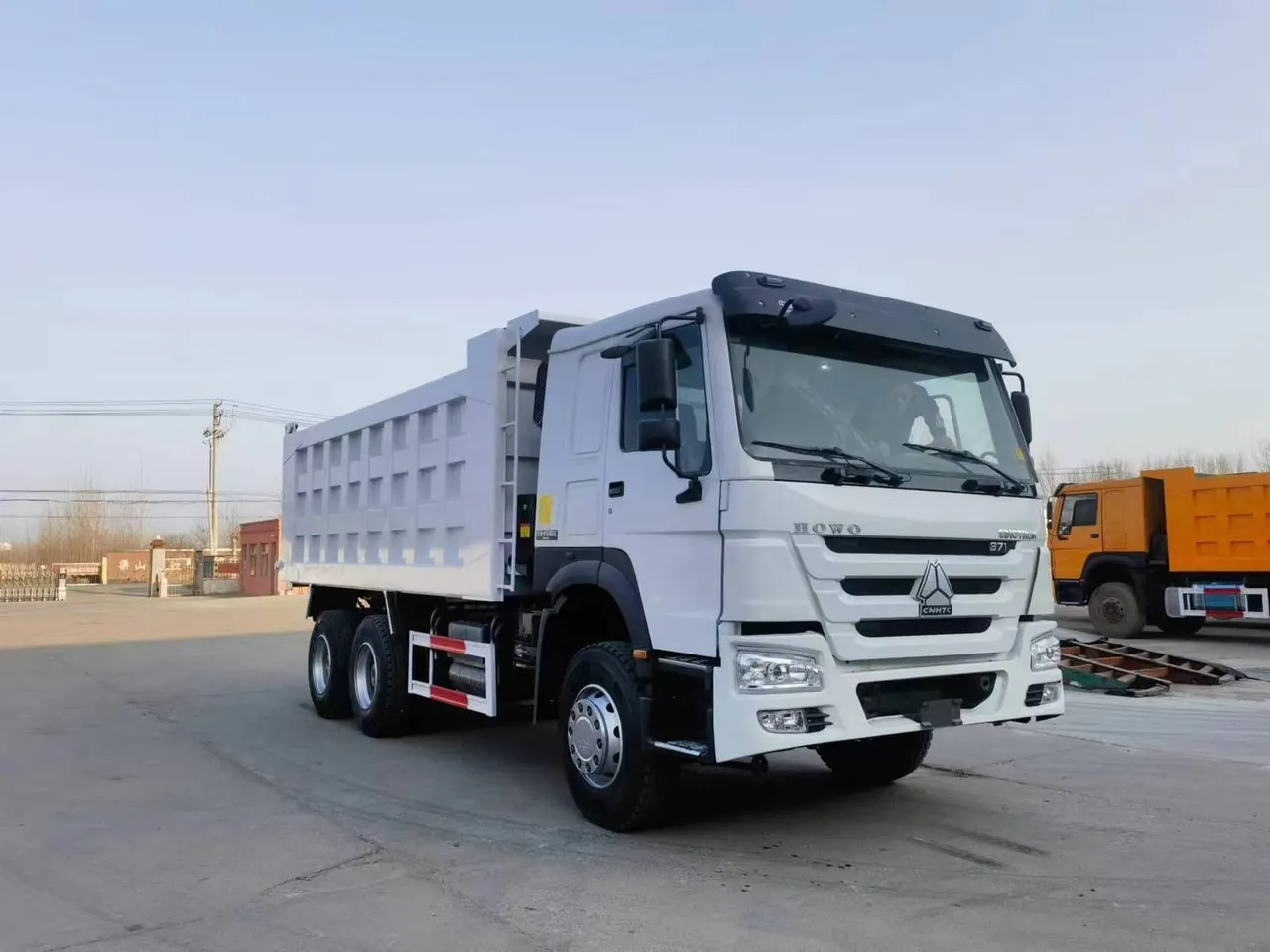 20 ton 6x4 dump truck loaded on port ready for export, HOWO tipper in orange