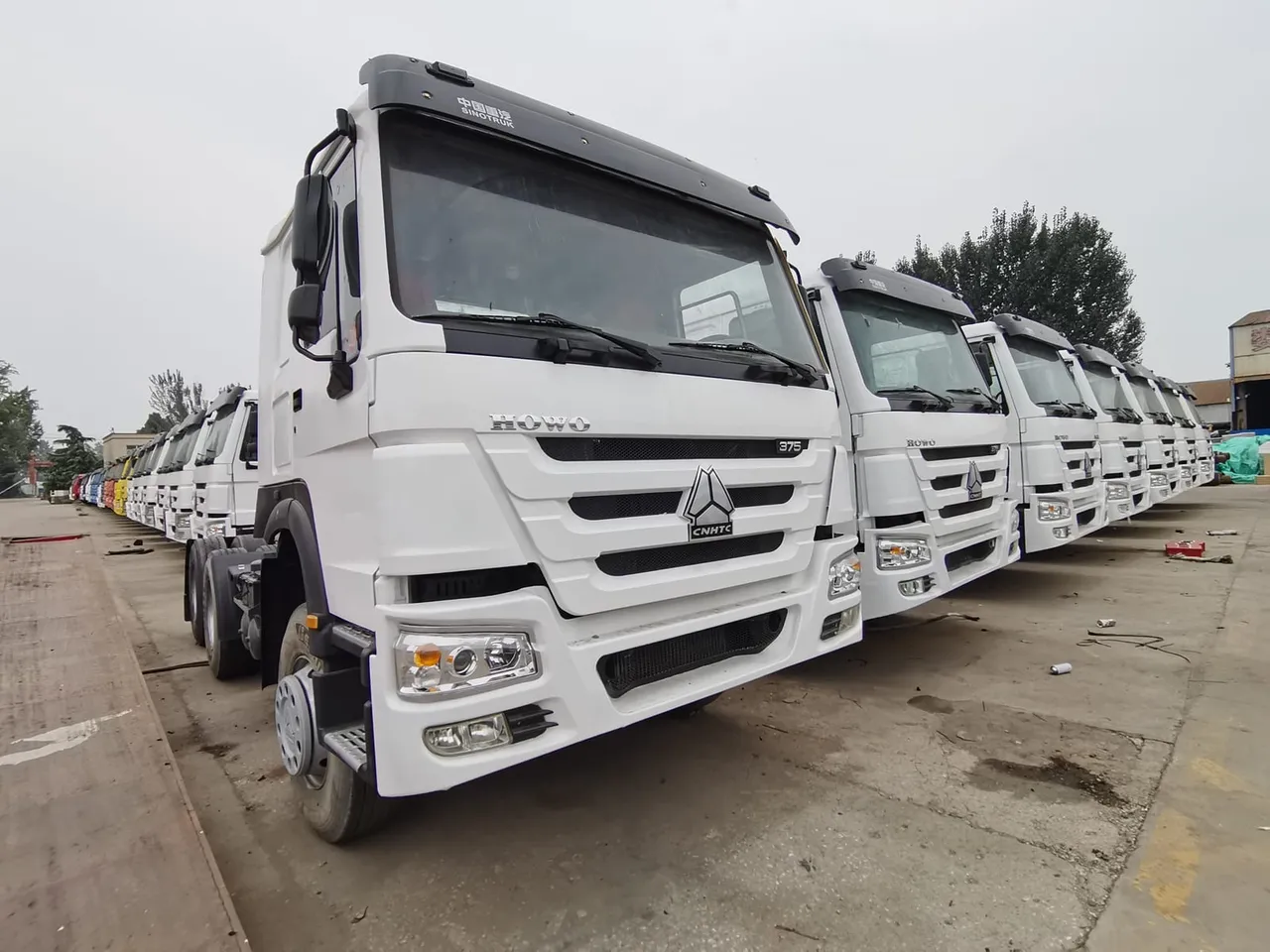 Used HOWO tractor head 6x4 lined up at Sigma Truck export yard ready for CIF shipping to Africa